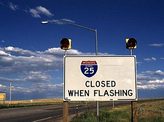 Like I-80 and I-90, Interstate 25 between major towns can be closed due to inclement weather. This closure sign is located near Douglas along I-25. The highway is closed when the beacon lights are flashing.