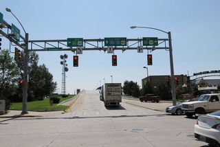 Southbound Business Loop I-25, U.S. 85, and Business U.S. 87 follow Central Avenue to Lincolnway (Junction Business Loop I-80, U.S. 30). This is the first Interstate 180 shield along southbound Central Avenue. The highway prepares to cross the railroad viaduct.