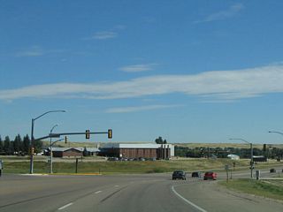 Eastbound U.S. 30 approaches Pershing Boulevard, a major east-west street that crosses the city of Cheyenne between Interstate 25 Exit 11 (near the Randall Avenue/F.E. Warren interchange) and passes the UMC and VA hospitals en route to this traffic signal. Pershing Boulevard is the first generation alignment of the Lincoln Highway; U.S. 30 is the second and newer generation of that historic road.