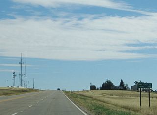 This mileage sign provides the distance to Pine Bluffs (at the state line between Wyoming and Nebraska) and Omaha, some 495 miles distant from here via U.S. 30 and Interstate 80.