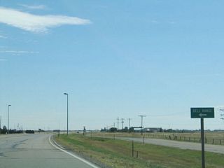 As Lincolnway continues to travel in a northwesterly direction, it intersects another major east-west roadway: Dell Range Boulevard. Dell Range extends west from here to a major commercial corridor, where many "big box" stores and the local mall can be found. Dell Range skirts the north edge of Cheyenne Airport before ending at Wyoming 219 (Yellowstone Road, which is former U.S. 85-87; before 1936, what is now Wyoming 219 was then U.S. 185).