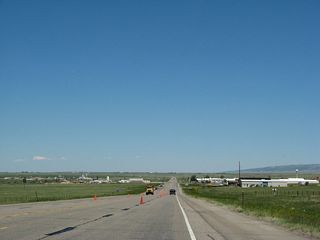 U.S. 30 and U.S. 287 retains four lanes as it leaves the urban area of Laramie and enters an industrial strip north of town.
