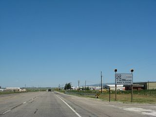 A white regulatory sign advises motorists that U.S. 30 and U.S. 287 are closed 17 miles ahead when the lights are flashing. Usually these lights illuminate during severe inclement weather.