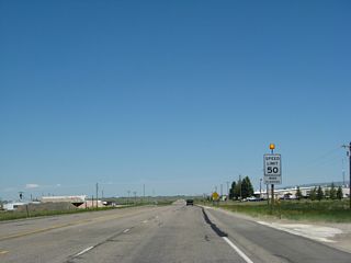 The speed limit increases to 50 miles per hour. What's odd is that this speed limit is only in effect when the light above the sign is flashing, which it was doing when we passed through the area. It's more common to see this sort of sign assembly for a school zone.