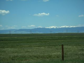 Even in early summer and late June, snow is plainly visible from U.S. 30-287 on the peaks of the Snowy Range, which is more formally known as Medicine Bow Mountains. Wyoming 130/Snowy Range Road travels west into and over the mountain range between Laramie and Saratoga.