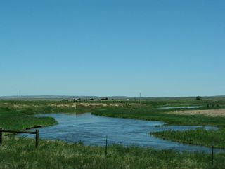 The Laramie River flows northeast toward the Laramie Mountains as part of the North Platte River watershed.
