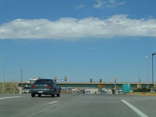 North of Fox Farm Road (Wyoming 221) Business Loop I-25, U.S. 85, and Business U.S. 87 next meet I-80 / I-180. I-80 travels east to Pine Bluffs and Nebraska and west to Laramie and Salt Lake City. I-180 follows U.S. 85 north on Central Avenue to downtown. The ensuing portion of U.S. 85 to Lincolnway (I-80 Business Loop) was funded as an Interstate and given the I-180 designation.