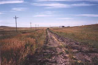 An old alignment of U.S. 85 is visible parallel to the modern Greeley Highway adjacent to the divided highway segment. The power lines help to locate the original segment of U.S. 85.