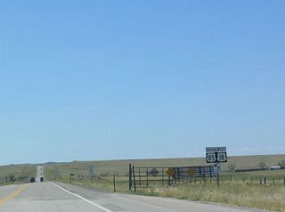 U.S. 18 is cosigned superfluously with U.S. 85 between Mule Creek Junction and Lusk. U.S. 18 could end at Mule Creek Junction, but since that endpoint is so far removed from anywhere, it was decided in 1968 to extend U.S. 18 to Orin Junction, where the highway meets Interstate 25. Note the CanAm Highway trailblazer shield posted below U.S. 85 and U.S. 18.