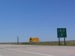 Southbound U.S. 85 and westbound U.S. 18 merge together here at Mule Creek Junction. A rest area is located at the northeastern corner of the intersection, but there are no other services available here. To Edgemont, South Dakota, take U.S. 18 east. In South Dakota, U.S. 18 continues east to Hot Springs, Oglala, Pine Ridge, Martin, Winner, Burke, Lake Andes, Olivet, and Canton. The highway travels through northern Iowa, and it ends in downtown Milwaukee, Wisconsin, on the shores of Lake Michigan.