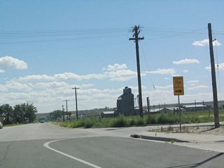 Southbound U.S. 85 and eastbound Wyoming 92 reach the intersection with Wyoming 156 just north of a railroad crossing.