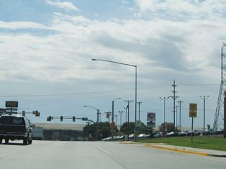 Another Wyoming 221/Fox Farm Road trailblazer shield is posted along southbound Business Loop I-25 and U.S. 85-87B.