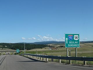 Now traveling southbound after the intersection with Old U.S. 14 (I-90 Frontage Road), southbound Wyoming 111 next approaches the interchange with Interstate 90 and U.S. 14 south of Aladdin and west of Beulah. The next right connects to Interstate 90 and U.S. 14 west to Sundance and Gillette.