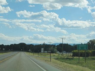 Southbound Wyoming 130 enters the town of Saratoga, which is home to 1,726 people. The town has a history in lumber, but it has grown to include tourism as a gateway to the Snowy Range and as the location of the Hobo Hot Springs in downtown Saratoga.