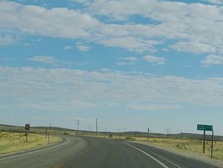 This mileage sign, located immediately after leaving Saratoga, provides the distance to Walcott Junction (20 miles) and Rawlins (41 miles). Follow Interstate 80 west to Rawlins.