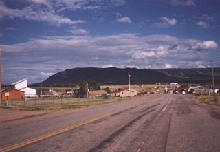 Plenty of ranches surround Centennial; a small downtown is located near a bend in the highway.
