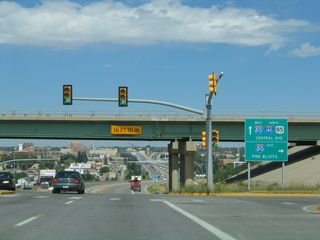This is the first trailblazer sign for northbound Interstate 180 to be seen from northbound U.S. 85, Business Loop I-25, and Business U.S. 87. The two business routes are not mentioned on most of the guide signs, but U.S. 85 and Interstate 180 generally are mentioned. At the Fifth Street and Ninth Street traffic signals, the mast arms identify the highway as "I-180." This traffic signal is the ramp connection to eastbound Interstate 80 en route to Pine Bluffs and Nebraska.