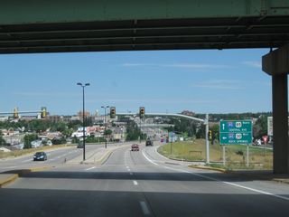 Northbound Interstate 180 and U.S. 85 pass under Interstate 80. The valley formed by Crow Creek cradles downtown Cheyenne; notable buildings include the state capitol building and a variety of mid-rise, western style buildings.