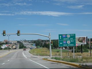 After passing under Interstate 80, a left turn at this traffic signal connects to westbound Interstate 80 en route to Laramie and Interstate 25. Interstate 180 (and Business Loop I-25, U.S. 85, and Business U.S. 87) continue straight ahead toward downtown Cheyenne.
