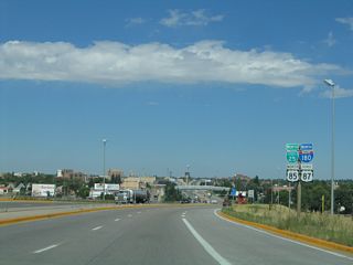 This is the first reassurance shield assembly on northbound Interstate 180 (and Business Loop I-25, U.S. 85, and Business U.S. 87). Notably, Interstate 180 is given a lesser status than Business Loop I-25, even though the guide signs generally omit Business Loop I-25 at the Interstate 80 diamond interchange. Note that the Interstate 180 shield is neutered; it was replaced in 2001. The previous shield contained the state name.