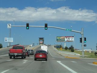 Northbound Interstate 180, Business Loop I-25, U.S. 85, and Business U.S. 87 meet Ninth Street at this traffic signal. The viaduct over the Union Pacific Railroad rises after the Ninth Street intersection.