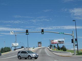 Still at the Ninth Street traffic signal, we see some changes between 2005 and 2010. The street light poles had been replaced, and new advance route markers for the upcoming Business Loop I-80 junction were installed at the base of the Union Pacific Railroad viaduct.