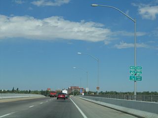 Northbound Interstate 180/Central Avenue approaches its final junction, the intersection with Lincolnway (Junction Business Loop I-80 and U.S. 30). Lincolnway follows the north side of the railroad. Turn left on Lincolnway to downtown and the historic rail depot. The approaching junction is first identified by these two business loop shields. These shields were gone by 2010.