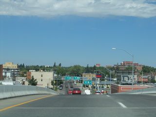 The intersection with Lincolnway (Business Loop I-80 and U.S. 30) comes into view on northbound Interstate 180, Business Loop I-25, U.S. 85, and Business U.S. 87. Use both lanes for through traffic onto Warren Avenue (Business Loop I-25), the left lane for westbound U.S. 30, and the right lane for eastbound U.S. 30.