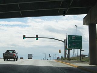 Interstate 180 comes to an end as Central Avenue passes under Interstate 80. Turn left here to follow Interstate 80 east to Pine Bluffs. Central Avenue changes into South Greeley Highway (U.S. 85) en route to south Cheyenne and thence onward toward Colorado.
