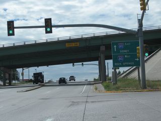 Southbound Interstate 180 reaches the ramp onto westbound Interstate 80 to Laramie and Rock Springs. The control cities on this sign changed in 2008 to match the signs found at the Interstate 25 and Interstate 80 interchange.