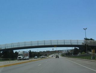 A pedestrian overcrossing passes over Interstate 180/Central Avenue.