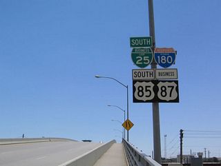 Before 2008, this was the first set of reassurance shields found along southbound Interstate 180, Business Loop I-25, U.S. 85, and Business U.S. 87. At that time, the Interstate 180 shield was the only standalone, state-name Interstate 180 shield. In 2008, this shield assembly was removed and not replaced, perhaps due to the installation of new bridge lighting.