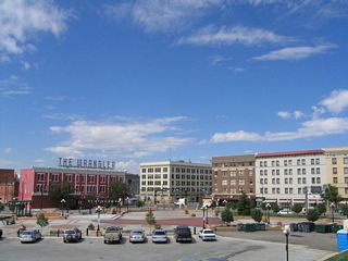 The historic buildings of downtown Cheyenne, including the railroad station, are visible from the sidewalk on the southbound viaduct of Interstate 180 looking toward the north.