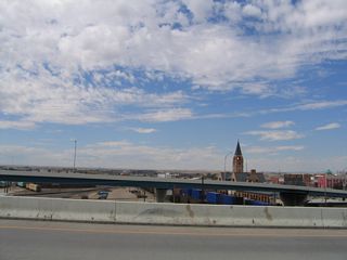 Two viaducts carry Interstate 180 (and Business Loop I-25, U.S. 85, and Business U.S. 87) over the Union Pacific Railroad. These bridges offer direct access into downtown Cheyenne from the south, and they cross over a huge railroad yard. This view looks west from the southbound bridge toward the northbound bridge and Cheyenne Depot Plaza.