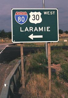 Interstate 80/U.S. 30 Signage at the Happy Jack/Wyoming 210 interchange which leads to the Sherman Hill Summit Rest Area between Cheyenne and Laramie. This sign is completely typical of interstate entry signs in Wyoming, which differ from other states in that the place name is given in unmodified Series E rather than mixed-case Series E Modified and lowercase letters. Although Wyoming follows the standard outline for Interstate route markers, the specific outline of the U.S. route marker has radius curves which are exaggerated compared to the federally standardized shield.