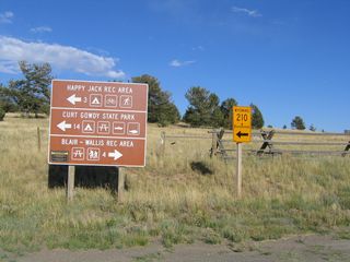 After departing from Interstate 80, this sign assembly provides directions to the various parks and recreational sites located near Sherman Hill. Turn right to the Summit Rest Area and the Blair-Wallis Recreation Area. Turn left and follow Wyoming 210 east to Happy Jack Recreation Area and Curt Gowdy State Park.