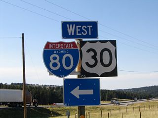 On the road leaving the Summit Rest Area, a left turn takes traffic west on Wyoming 210 to the interchange with Interstate 80 and U.S. 30, while a right turn follows Wyoming 210/Happy Jack Road east through the Pole Mountain area toward Curt Gowdy State Park and Cheyenne.