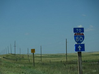 This trailblazer replaced a guide sign by 2006 that directed motorists to continue on WYO 225 (Otto Road) west to return to I-80 en route to Laramie.