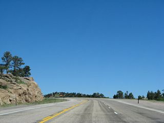 U.S. 287 leaves Colorado and enters Wyoming as a three-lane highway with two lanes northbound; it will ascend from here to the 8,106-foot summit of Pumpkin Vine Hill. Once in Wyoming, the middle lane is considered a "suicide" lane because it may be used by either direction of traffic legally. A feasibility study released in 2002 determined that U.S. 287 between the Colorado State Line and Laramie should be four lanes with a median. Portions of the route have been upgraded to this standard during the 2000s and 2010s.