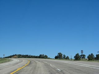 The first reassurance route marker for U.S. 287 north is posted soon thereafter; this sign features fairly small numerals, making it difficult to read when passing at high speeds. Work to expand this segment of U.S. 287 to four lanes with wide median was underway in summer 2014; we'll return to get pictures of the improved roadway.