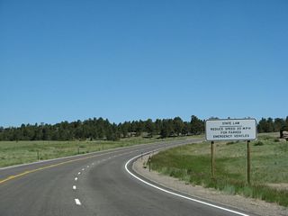 U.S. 287 continues north as a three-lane highway. A regulatory sign advises motorists of the state requirement that vehicles must move over or reduce speed when approaching parked emergency vehicles on the side of the highway.