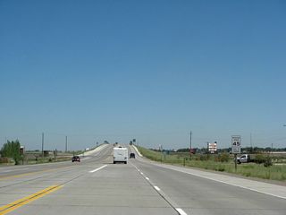 The speed limit along U.S. 287 north reduces to 45 miles per hour as the highway ascends another bridge that separates the highway from the Union Pacific Railroad.