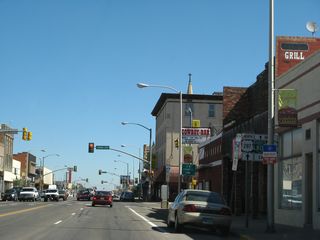 On the block between Garfield Street and Grand Avenue, we find a trailblazer shield assembly for the continuation of U.S. 287 north along Third Street as well as Business Loop I-80 and U.S. 30 east along Grand Avenue (right turn). Follow Grand Avenue east to the University of Wyoming. Ahead, U.S. 30-287 and Business Loop I-80 follow Third Street north.