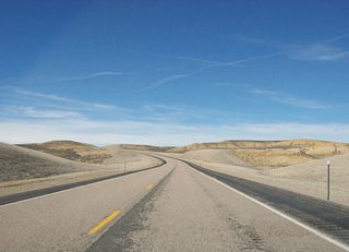Wyoming 530 is mostly two lanes as it travels north, with occasional passing lanes. Largely avoiding Flaming Gorge National Recreation Area, Wyoming 530 has several access points to the reservoir. The national recreation area is managed by the National Forest Service as a unit of Ashley National Forest. Most of Ashley National Forest is located in Utah, in the High Uinta Mountains. Explorer John Wesley Powell, who launched his exploratory expedition from Expedition Island in Green River city in 1869, followed the Green River south into Utah, and he named the Flaming Gorge due to its fiery red rock formation and cliff walls. Established on October 1, 1968, after the construction of the Flaming Gorge Dam and formation of Lake Flaming Gorge reservoir, the national recreation area consists of 207,363 acres.