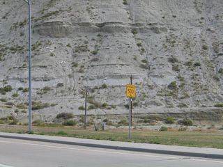 To reach Wyoming 530, follow Business Loop I-80 into Green River, then turn north onto the railroad viaduct. The four-lane highway makes a 180-degree turn, changing from a northbound to a westbound to a southbound direction. Almost immediately upon turning south, Wyoming 530 crosses a viaduct that carries the state highway over the Union Pacific Railroad tracks. This photo shows the first southbound Wyoming 530 (Uinta Drive) reassurance shield immediately after the business loop (Flaming Gorge Way) intersection.