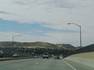 The southern portion of the city of Green River comes into view as Wyoming 530 (Uinta Drive) crests over the Union Pacific Railroad viaduct. A bridge that carries Wyoming 530 over the Green River is located about a quarter mile south of this point.