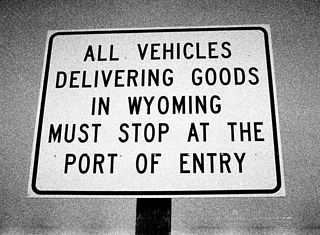 The next sign in sequence indicates that all vehicles delivering in the state of Wyoming must stop at the Port of Entry on northbound Wyoming 585.