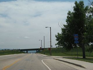 Southbound Wyoming 585 (Sixth Street) advances to the interchange with Interstate 90. I-90 travels west to Moorcroft, Gillette and Sheridan and east to Spearfish, South Dakota.