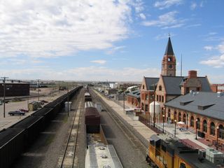 The historic railroad depot building anchors the Cheyenne Railroad Depot Plaza. Just south of the depot lies the railroad tracks, while the plaza sits between the depot and Lincolnway.