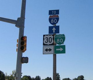 A close-up of the trailblazer shields at the Lincolnway intersection on southbound Wyoming 212/College Drive. Ahead, Business loop I-80 and Wyoming 212 share pavement until the two routes meet Interstate 80.